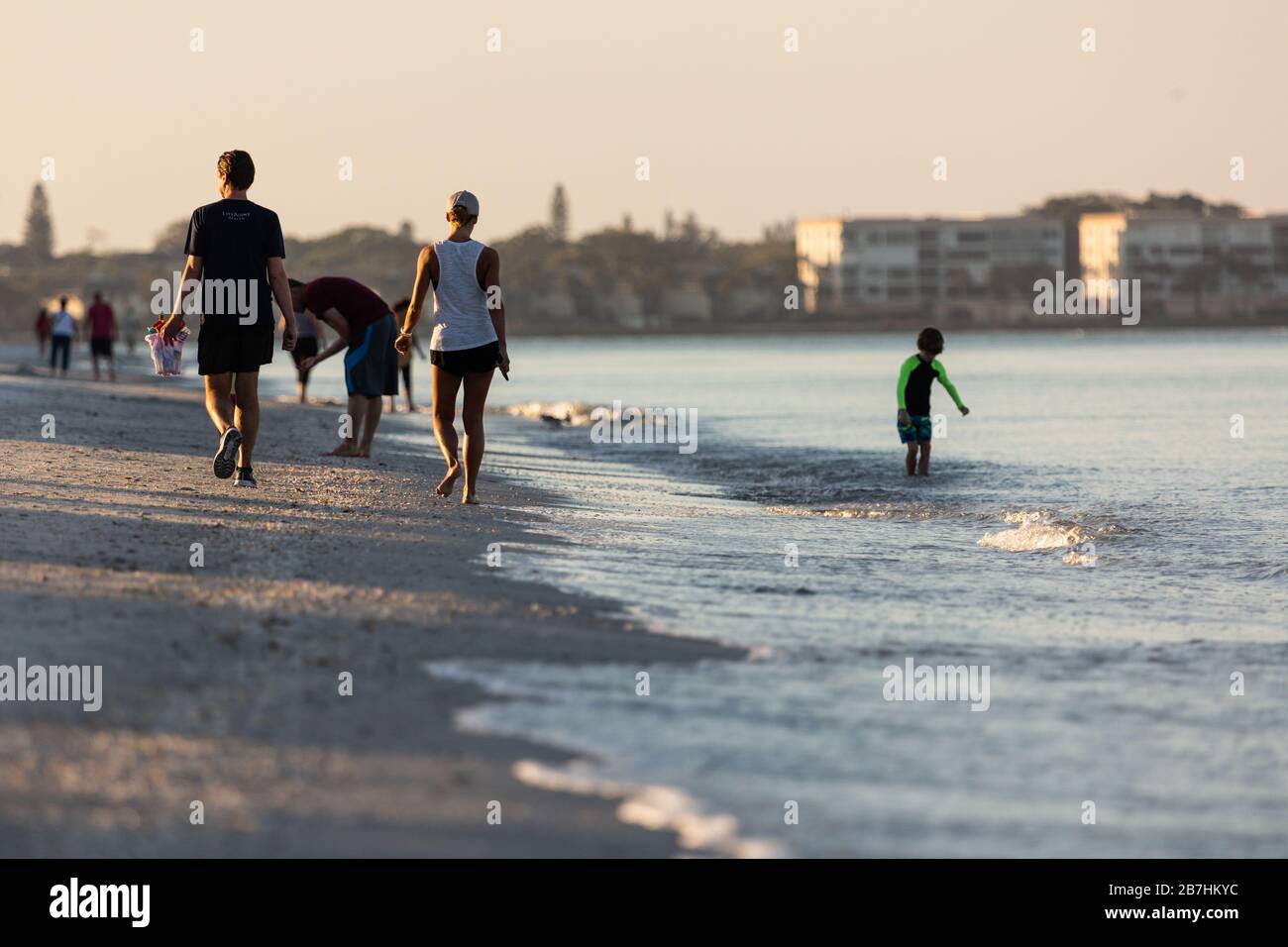 People gather on the beach at Lido Key just after sunrise on March 16, 2020 in Sarasota FL, USA. Stock Photo
