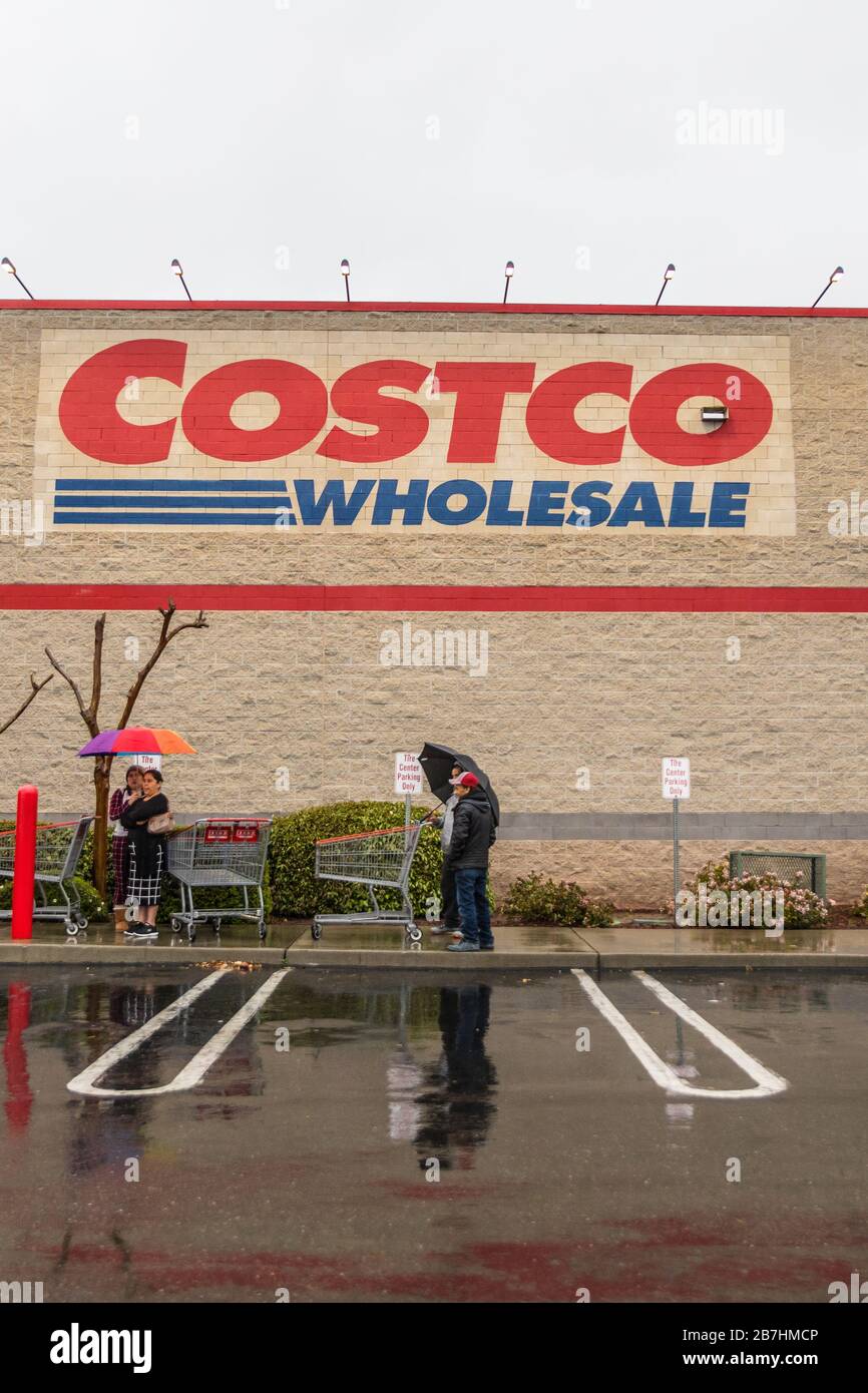 16 March 2020 Costco store Modesto California over 100  shoppers lined up in the rain 45 minutes before opening. Stock Photo