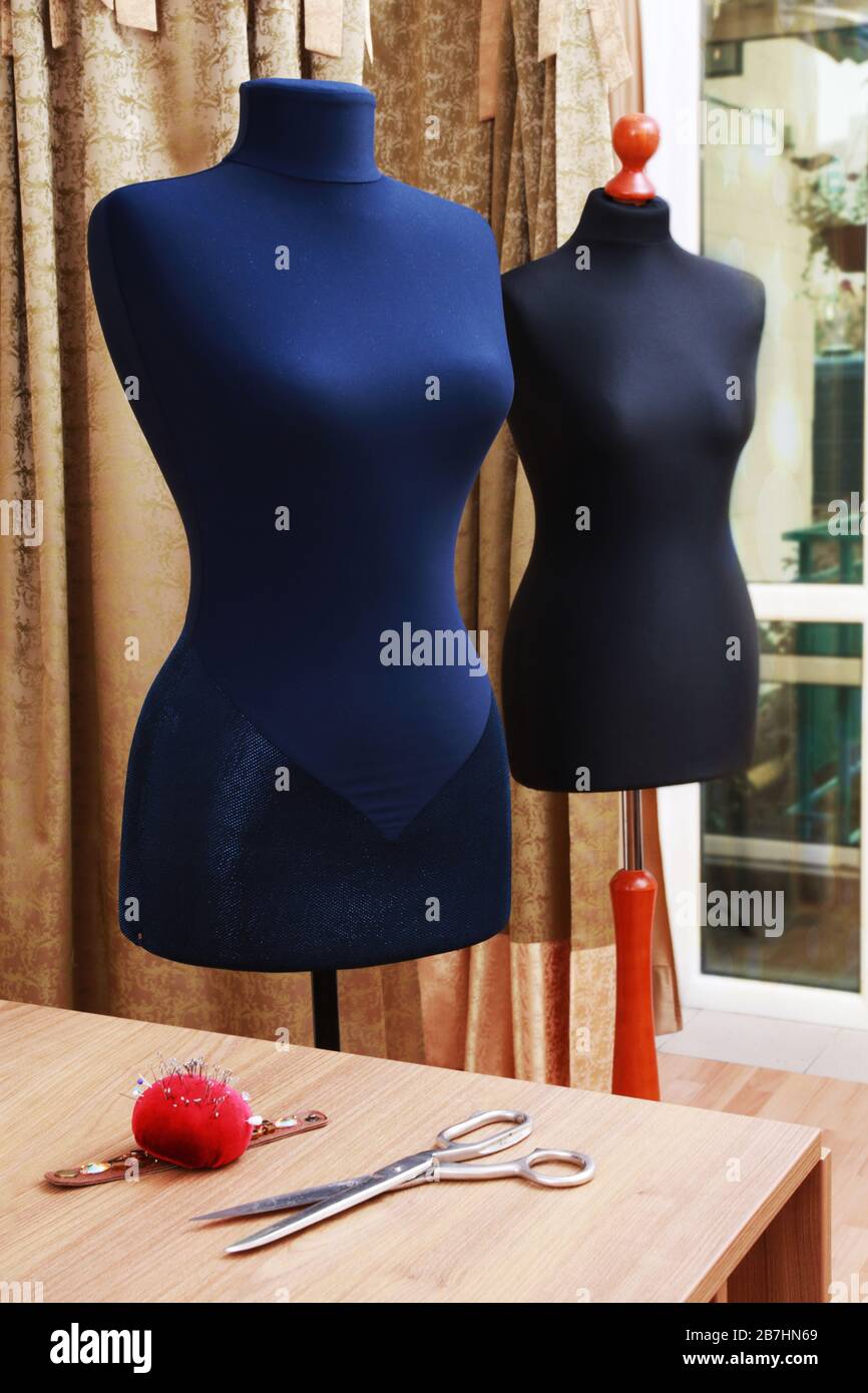 Fashion designer studio with dressmakers equipment. mannequins for