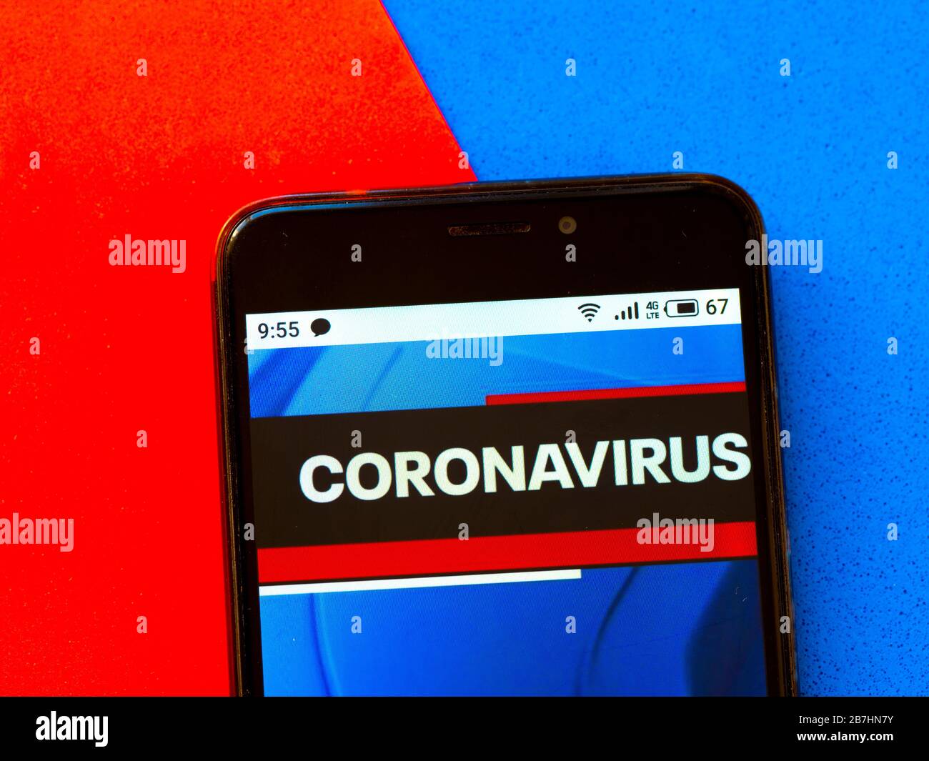 In this photo illustration a Coronavirus pandemic news report is seen displayed on a smartphone. Stock Photo