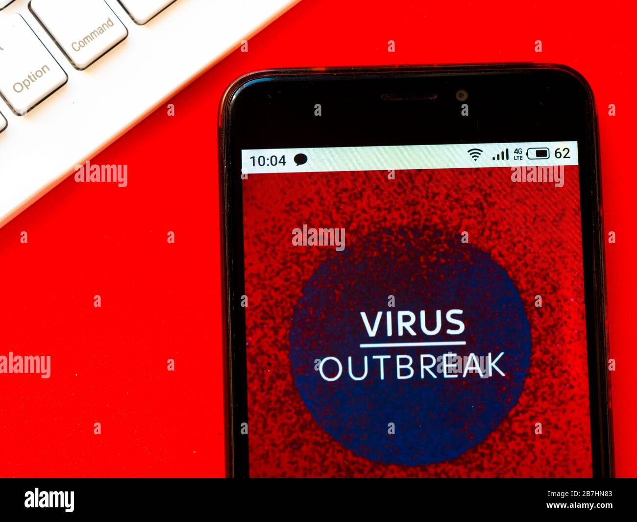 In this photo illustration a Coronavirus pandemic news report is seen displayed on a smartphone. Stock Photo