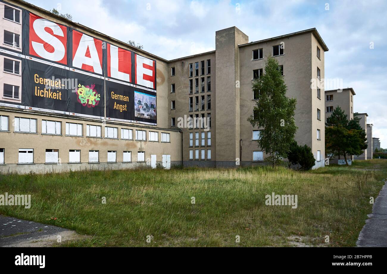 A poster at one of the buildings of the old Strength through Joy-buildings in Prora on the island of Ruegen shows the words SALE, GEMUETLICHKEIT (cosi Stock Photo