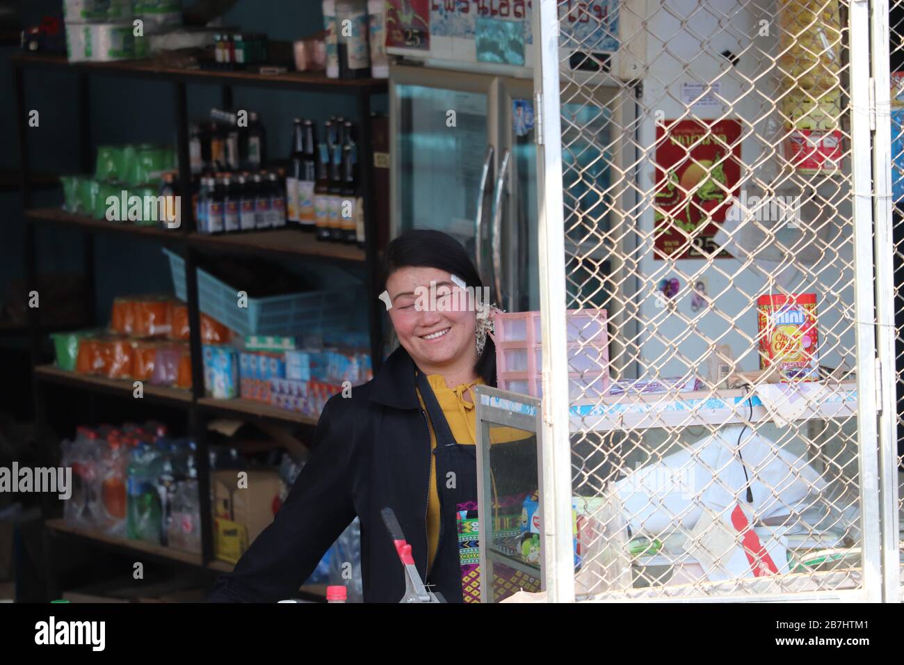 A THAI LADY WORKING IN HER SHOP IN MAE HONG SON NORTHERN THAILAND. Stock Photo