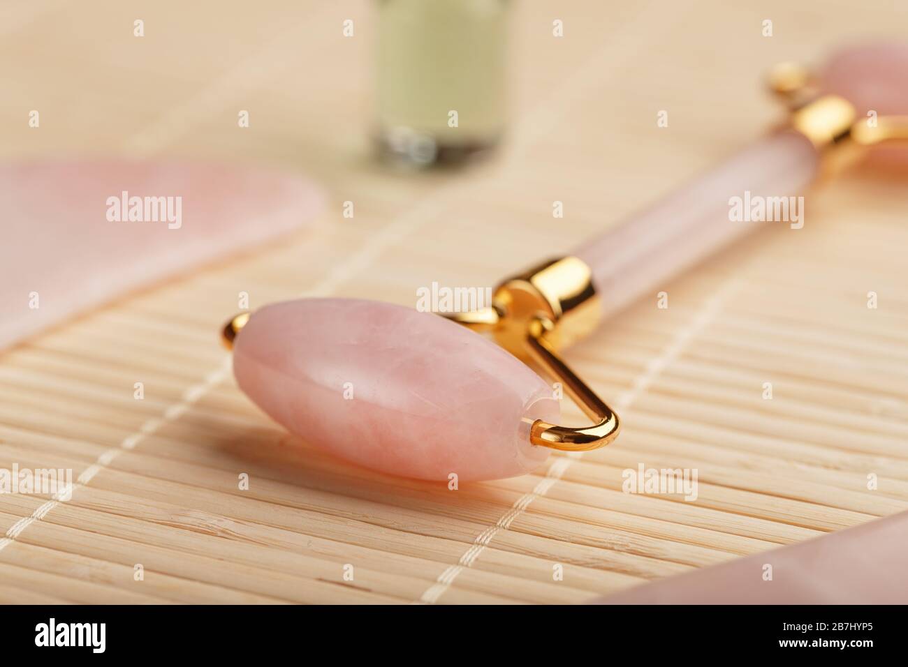 Gua sha massage made of natural rose Quartzroller, jade stone and oil