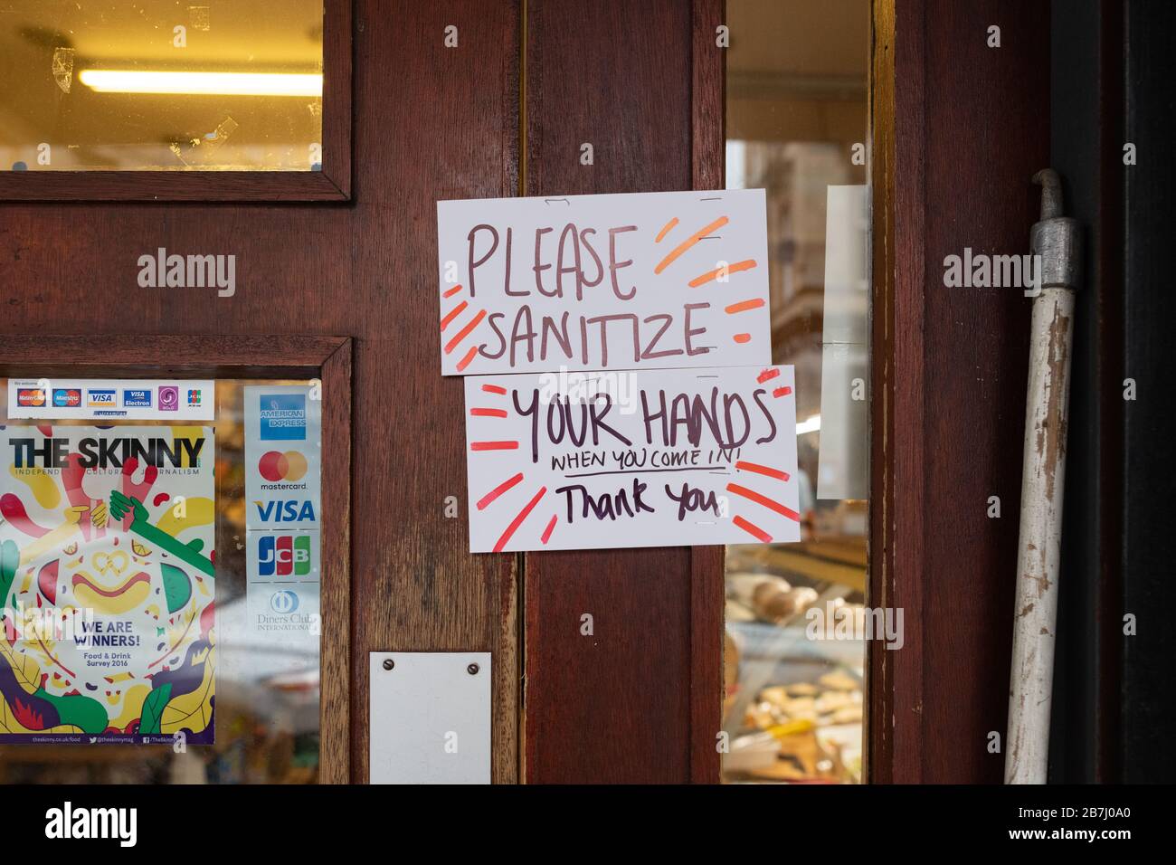 Finnieston, Glasgow, Scotland, UK - Roots, Fruits and Flowers, Finnieston, Glasgow, display a 'Please Sanitize Yours Hands when you come in' on the door, and provide sanitizer just inside the door Credit: Kay Roxby/Alamy Live News Stock Photo