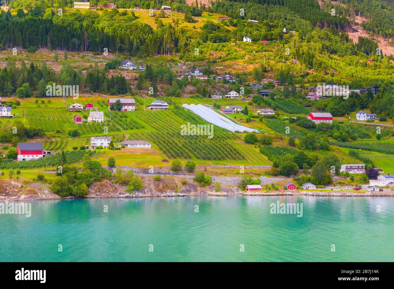 Norwegian village landscape with fjord, mountains and colorful houses ...