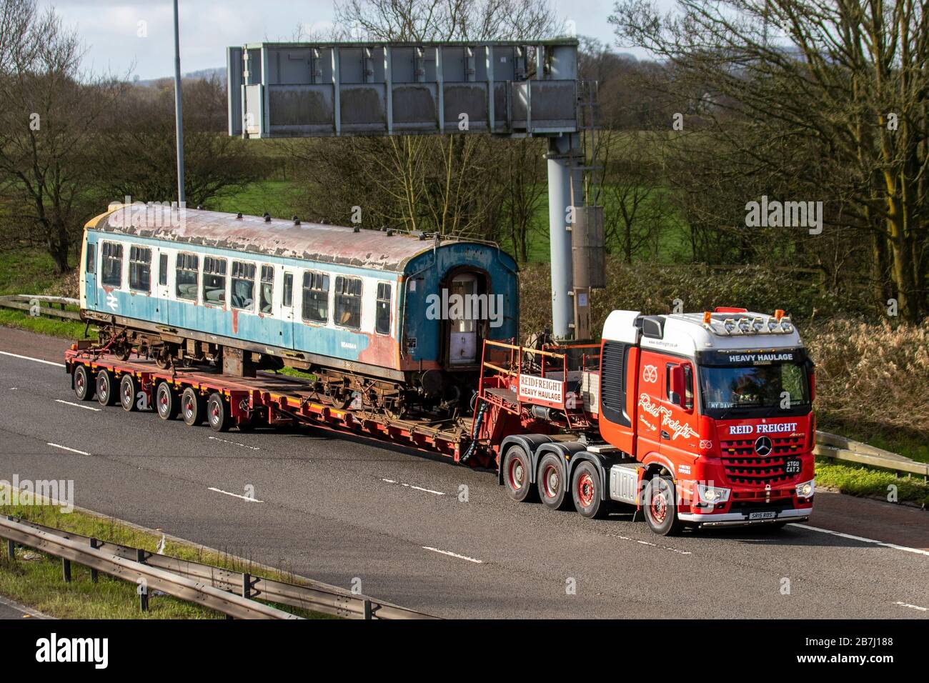 Reid Freight Heavy haulage; Longer Heavier Vehicles with trailer (LHVs) 6 axle trailer carrying old restorable railway carriages for restoration by a train PWRS. Poulton & Wyre Railway preservation society. Stock Photo