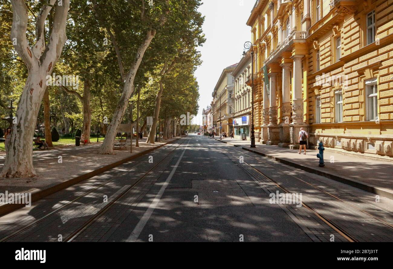 Zrinjevac square beautiful green treeline above road and tram railway Stock Photo