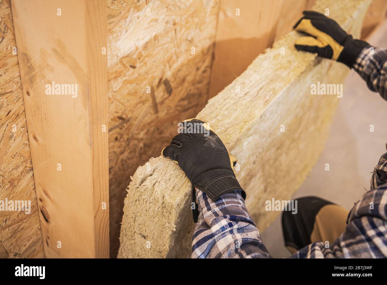 Synthetic Mineral Fibers Wall Insulation Job. Construction Worker