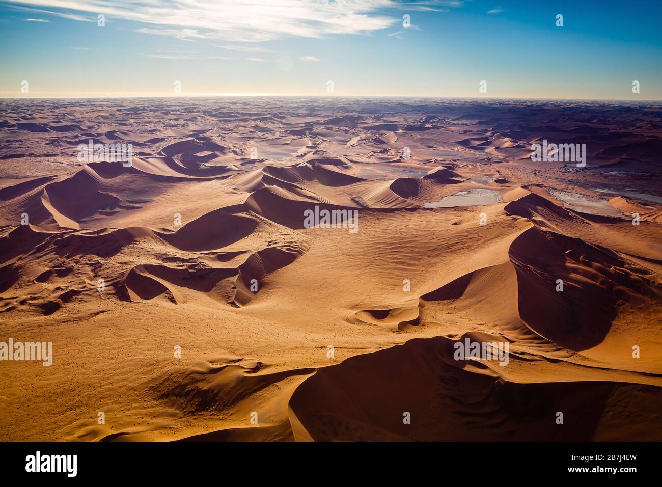 Sand dunes of Namib desert from aircraft on Skeleton coast in Namibia. Stock Photo
