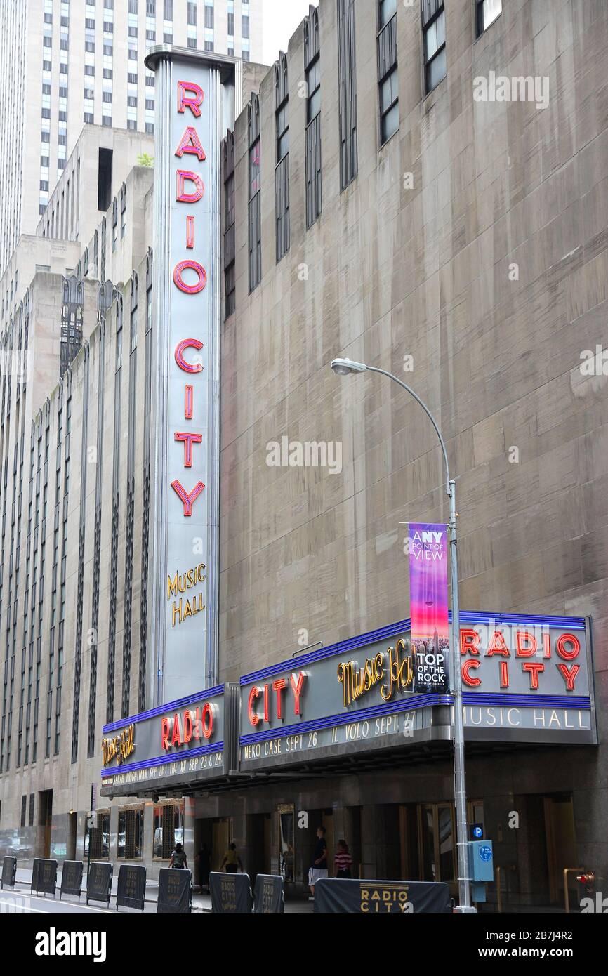 NEW YORK, UNITED STATES - JULY 1, 2013: People walk past Radio City Music Hall at 6th Avenue in New York. Radio City exists since 1932 and is register Stock Photo