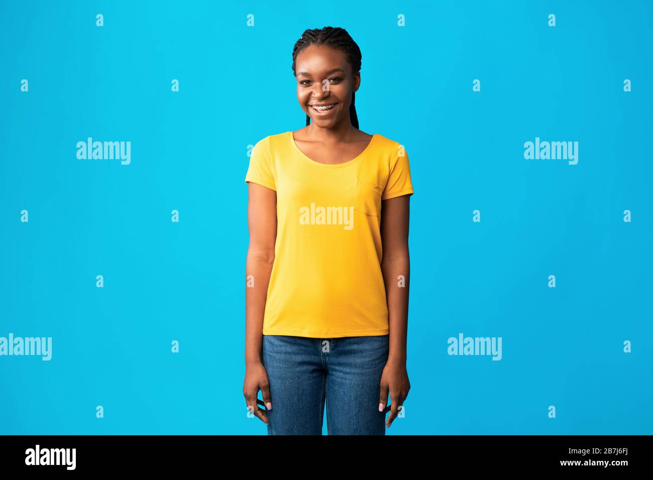 Black Girl In Braces Standing Smiling To Camera, Studio Shot Stock Photo