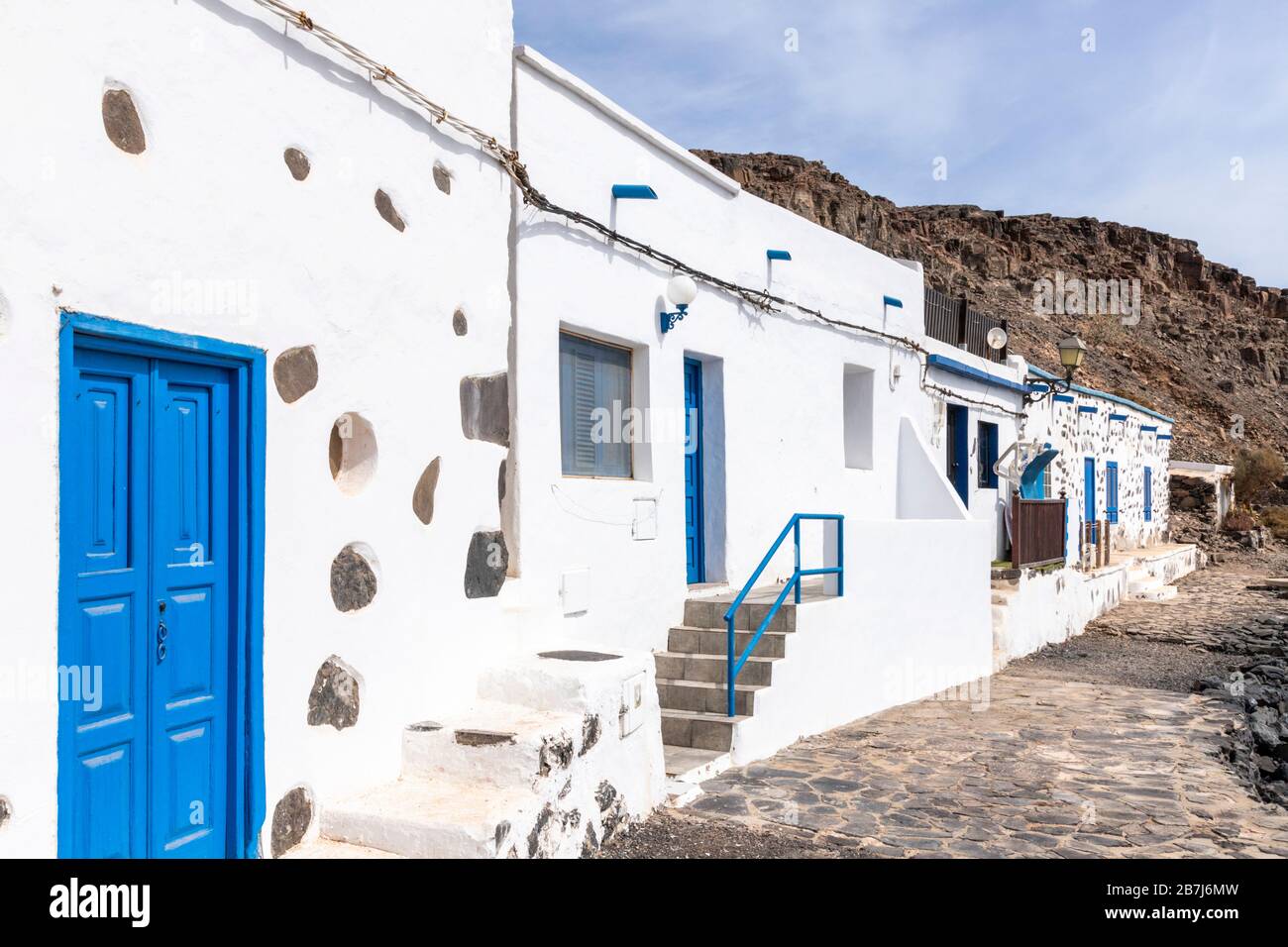 Traditional buildings facing the beach at Pozo Negro on the east coast of the Canary Island of Fuerteventura Stock Photo