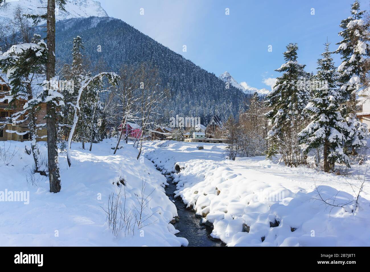 Channel Alibek in the ski resort village of Dombay in Karachay-Cherkessia. Sunny winter day Stock Photo