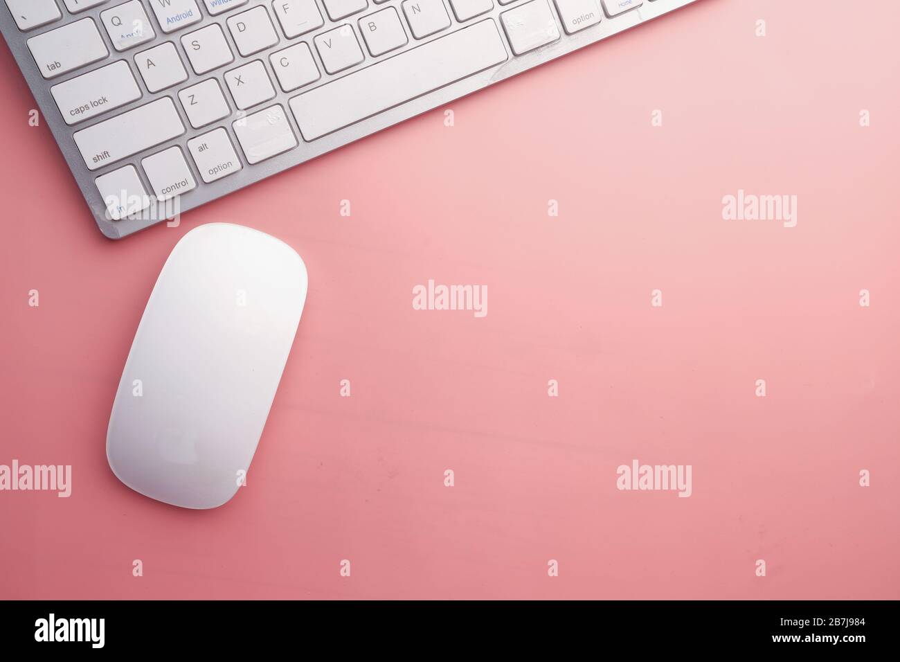 computer mouse and keyboard on pink background  Stock Photo