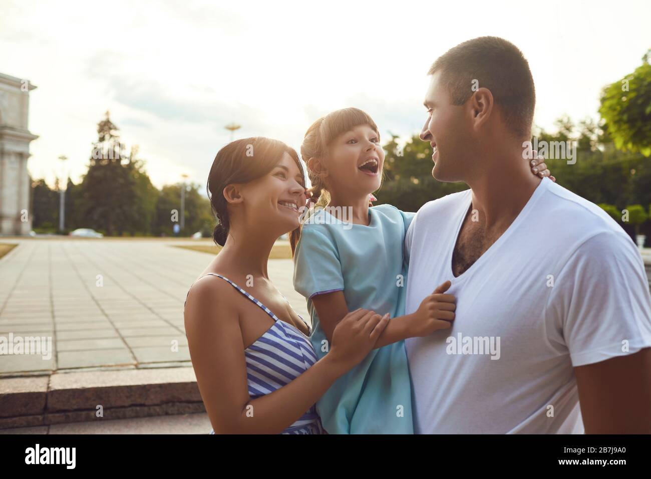 Happy smiling family walking on the street. Stock Photo