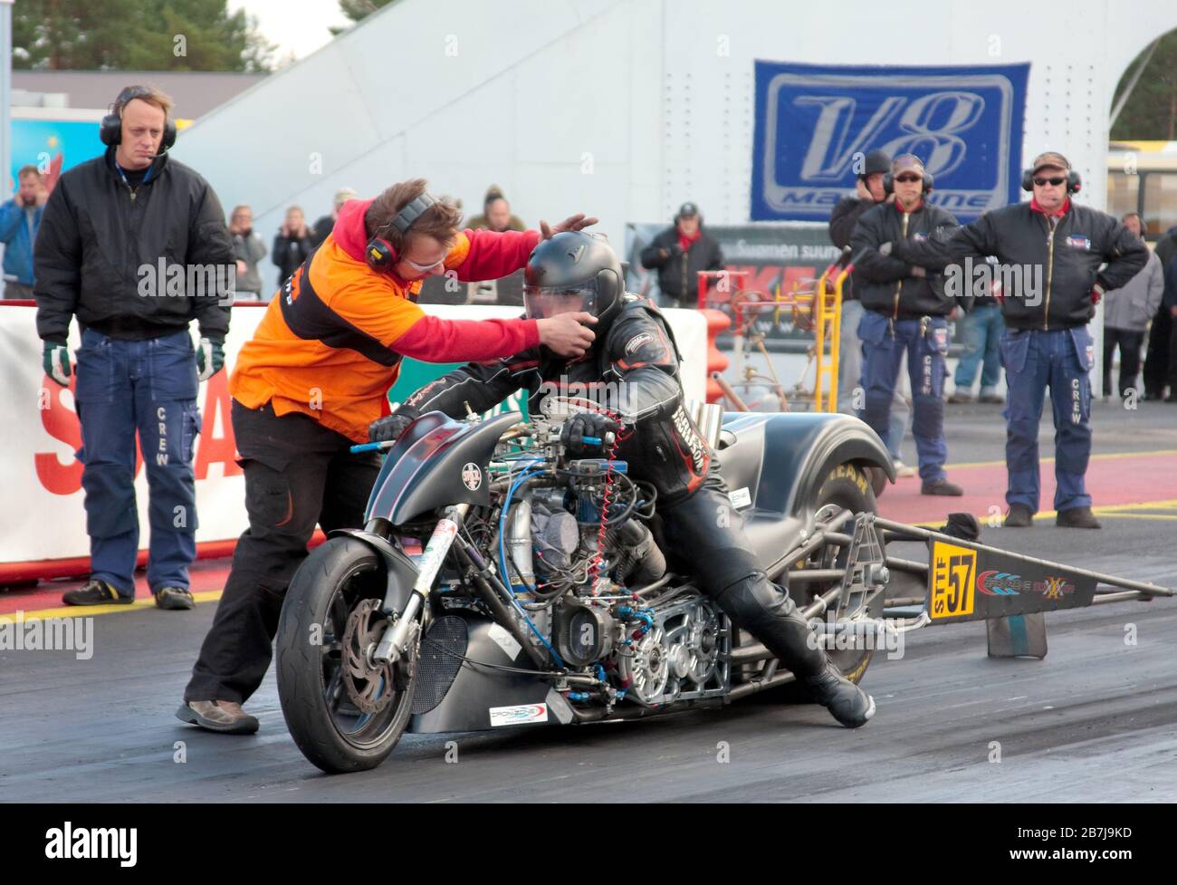 A drag race bike speeding up in quarter mile race with nitro burning