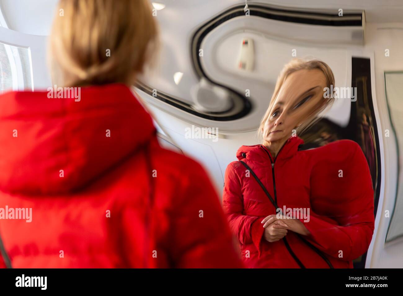 woman distorted in a mirror Stock Photo