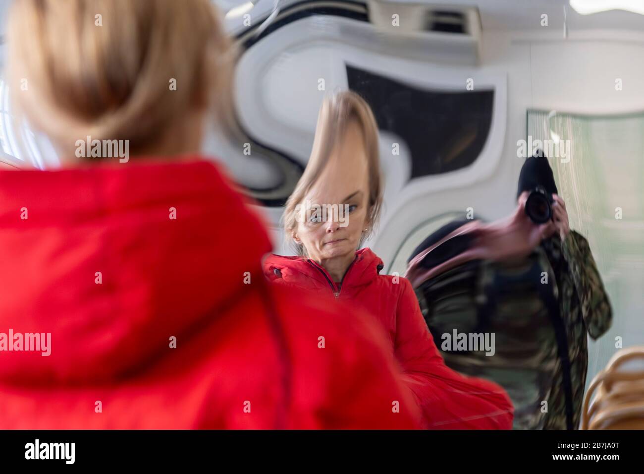 woman distorted in a mirror Stock Photo
