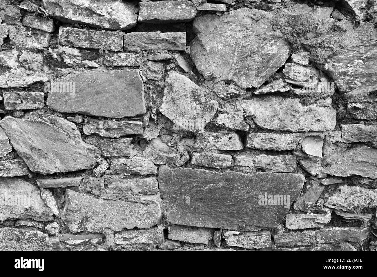 A black and white b/w closeup of an ancient castle wall. Elegant, historical, fortress antique wall with beautiful design. Architectural black and whi Stock Photo