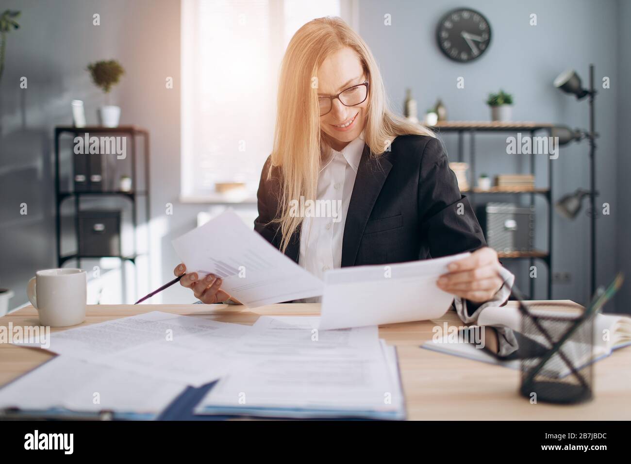 Happy mature woman paper work hi-res stock photography and images - Alamy