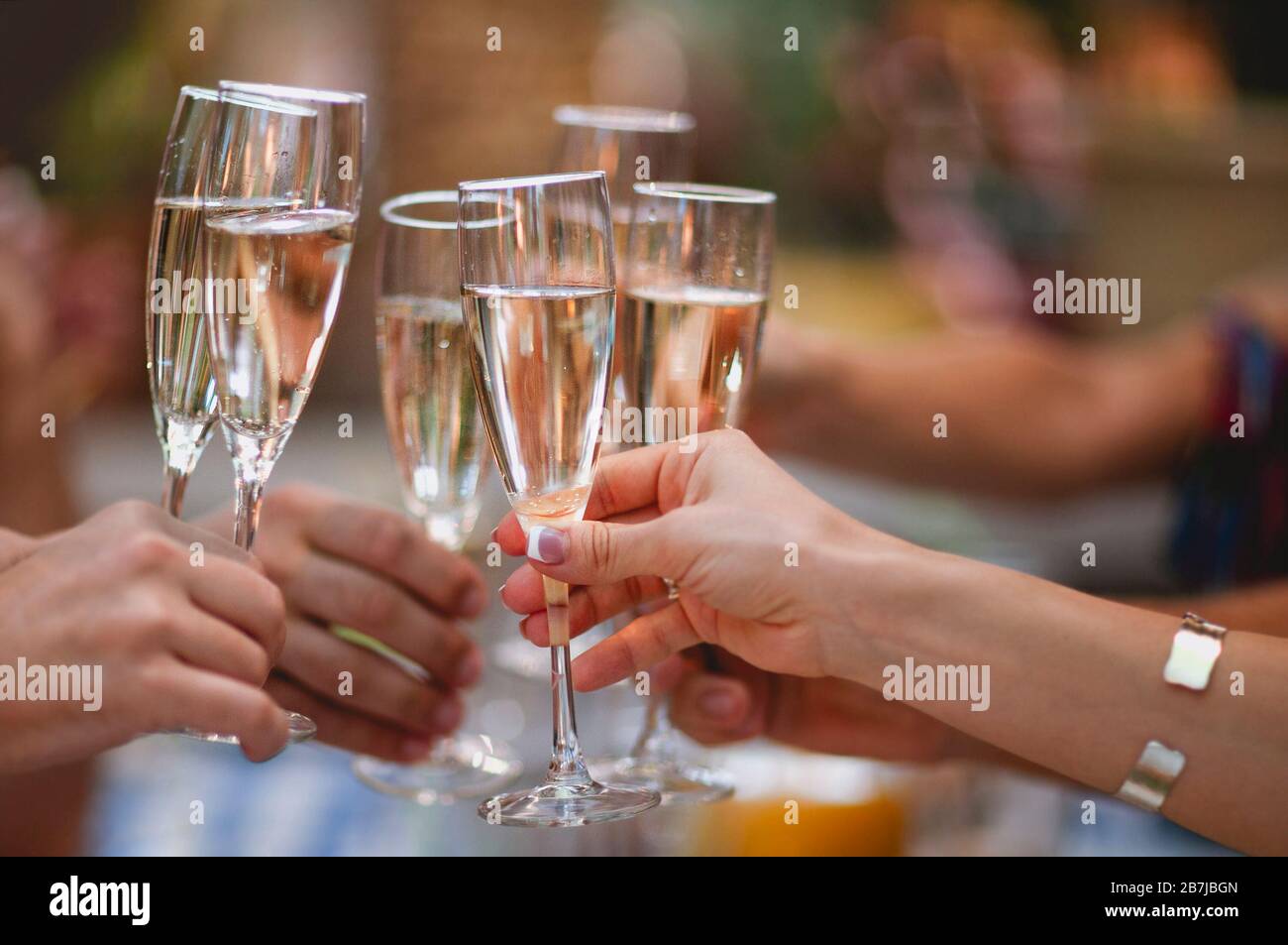 Celebration. People holding glasses of champagne making a toast ...