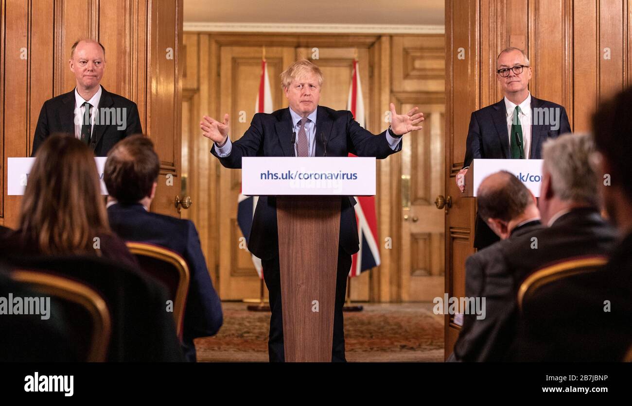 Chief Medical Officer for England Chris Whitty (left) and Chief Scientific Adviser Sir Patrick Vallance stand with Prime Minister Boris Johnson during a media briefing in Downing Street, London, on Coronavirus (COVID-19) after the government's COBRA meeting. Picture date: Monday March 16, 2020. See PA story HEALTH Coronavirus. Photo credit should read: Richard Pohle/The Times /PA Wire Stock Photo
