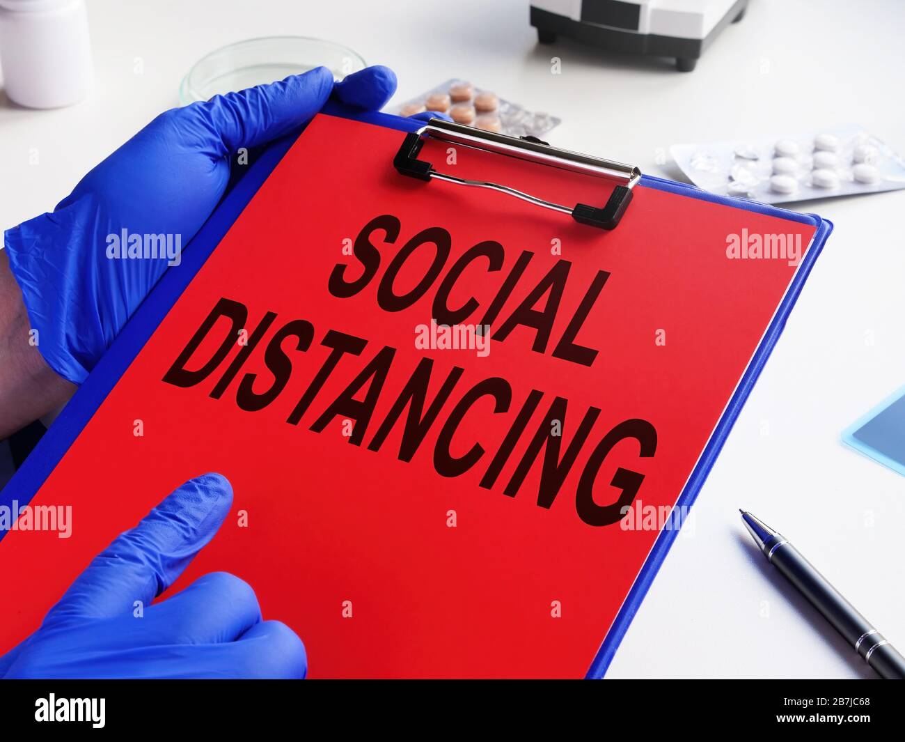 Doctor holds prescription Social distancing with coronavirus covid-19. Stock Photo