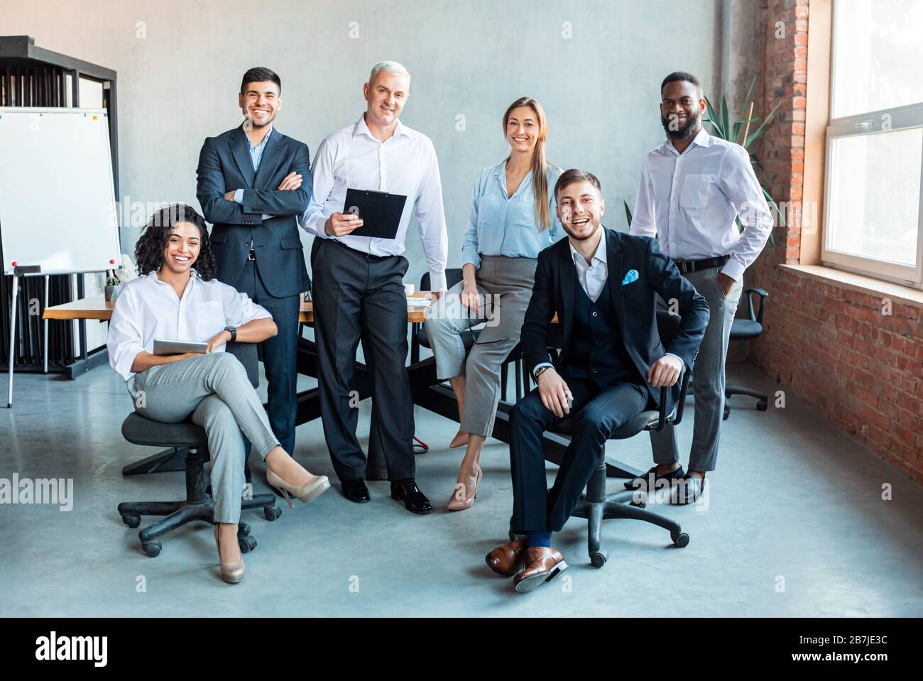 Group Of Successful Business People Posing At Workplace In Office Stock ...