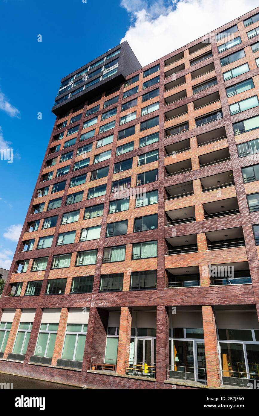 Facade of a modern residential skyscraper full of flats in Amsterdam