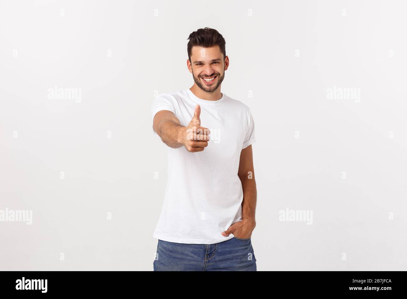 Young happy man with thumbs up sign in casuals isolated on white ...