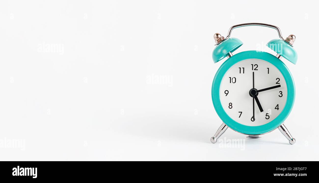 Turquoise alarm clock on white background. Banner, copy space Stock
