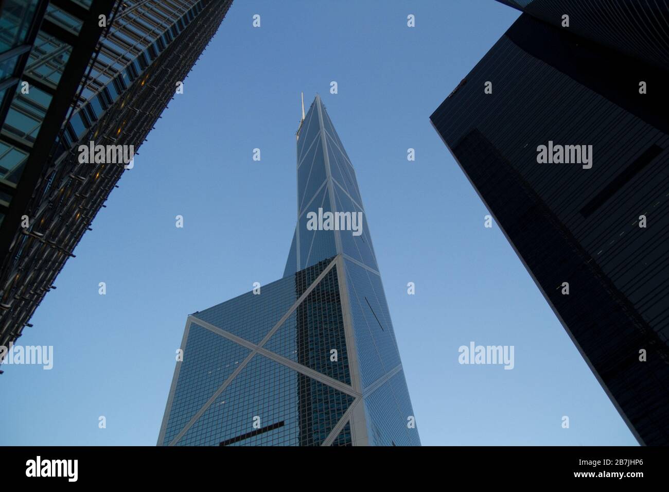 Skyscraper Tower Blocks in Hong Kong against blue sky Low angle Stock Photo