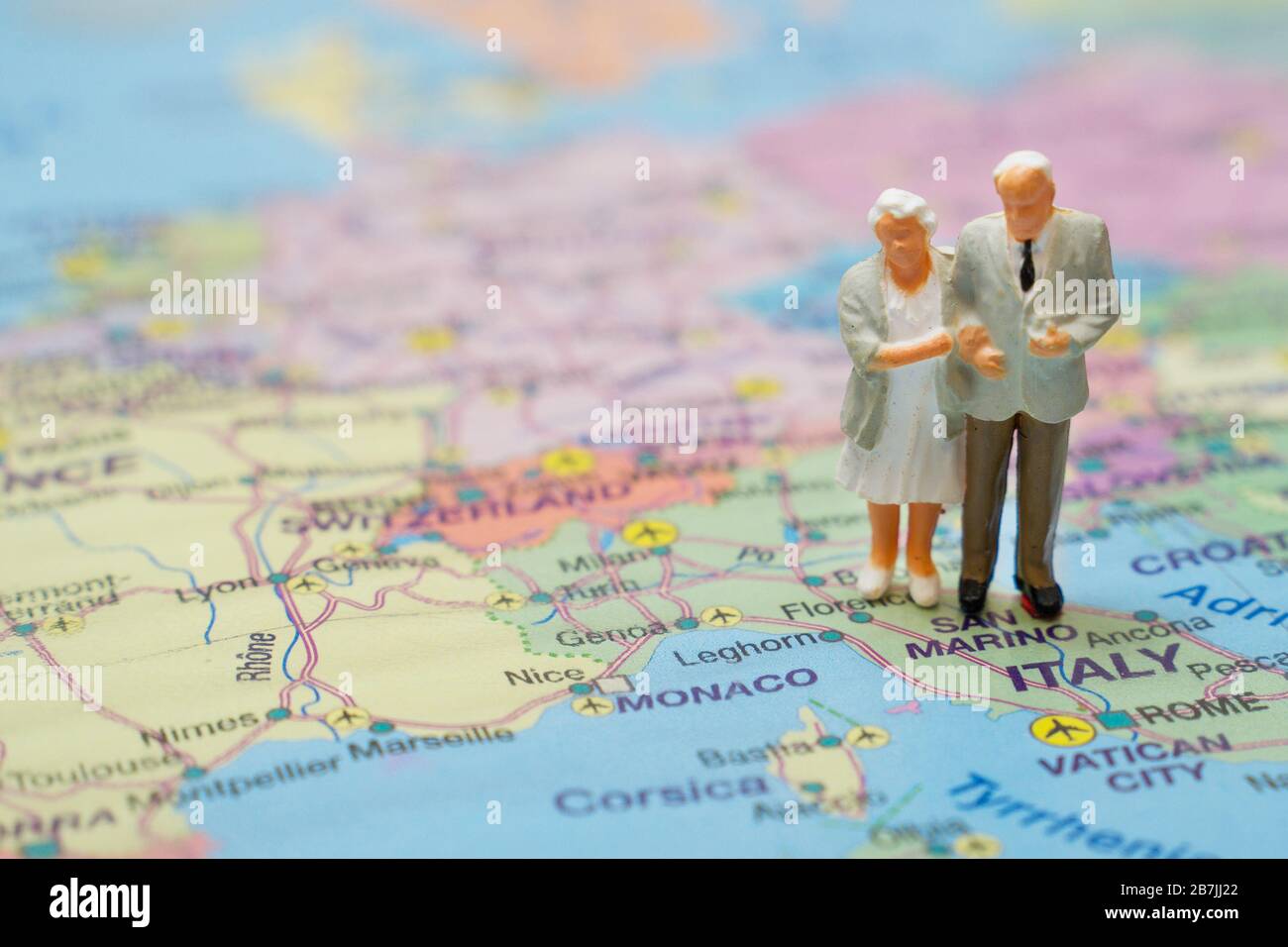Figures of the elderly couple on a map of Italy Stock Photo - Alamy