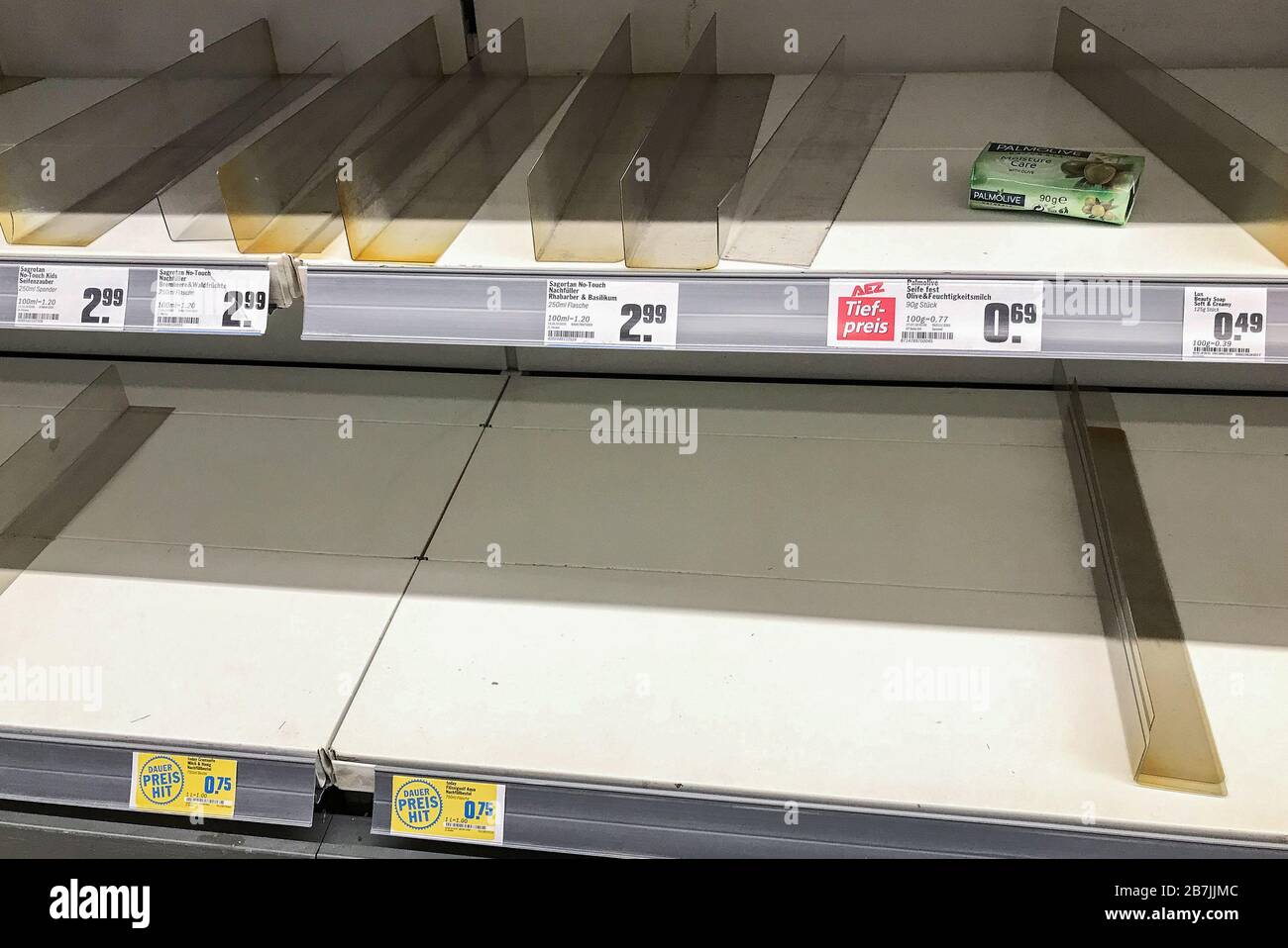 Munich. 16th Mar, 2020. Photo taken on March 16, 2020 shows empty shelves at a supermarket in Munich, southern Germany. Germany's Bavaria declared an emergency situation which will take effect from Tuesday, closing down leisure facilities such as swimming pools, bars, clubs or cinemas, Minister President of Bavaria Markus Soeder announced on Monday. Credit: Philippe Ruiz/Xinhua/Alamy Live News Stock Photo