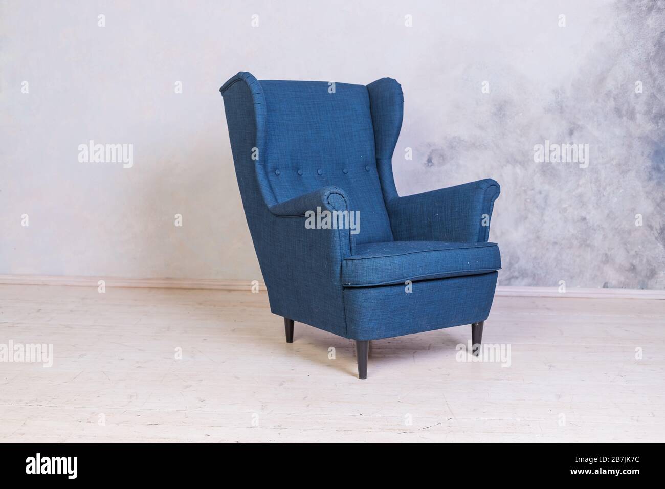 Classic blue chair. loft interior.Comfortable armchair against concrete  wall background.Scandinavian style.Minimal Modern Furniture Recliner Object  in Stock Photo - Alamy