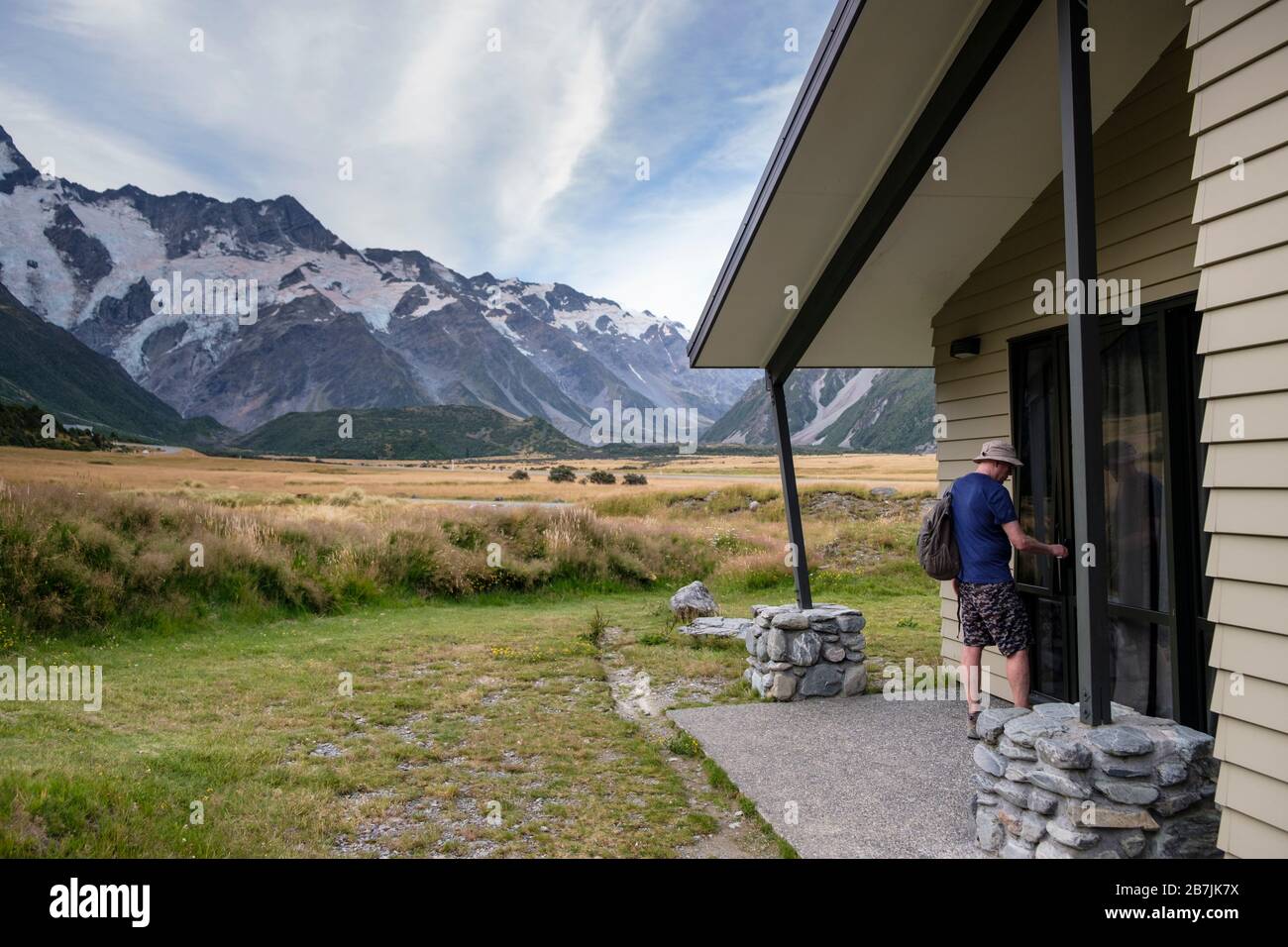 Man entering Hotel Lodging at Aoraki/Mount Cook National Park, South Island, New Zealand Stock Photo