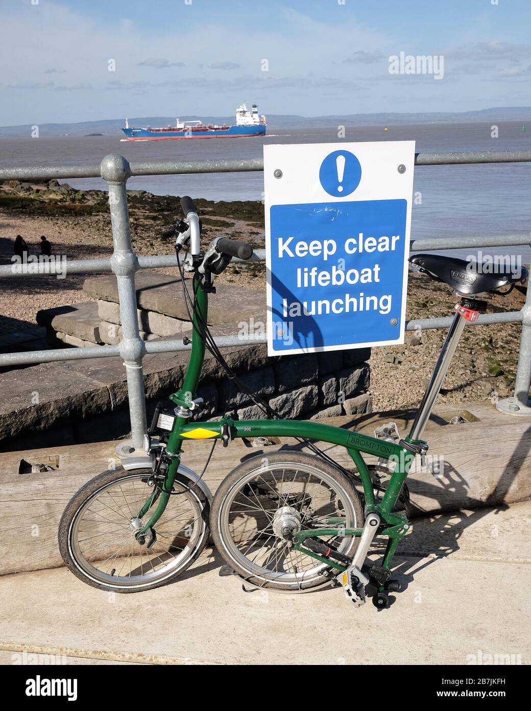 March 2020 - Green Brompton folding bike at the lifeboat launching ramp in Portishead Stock Photo