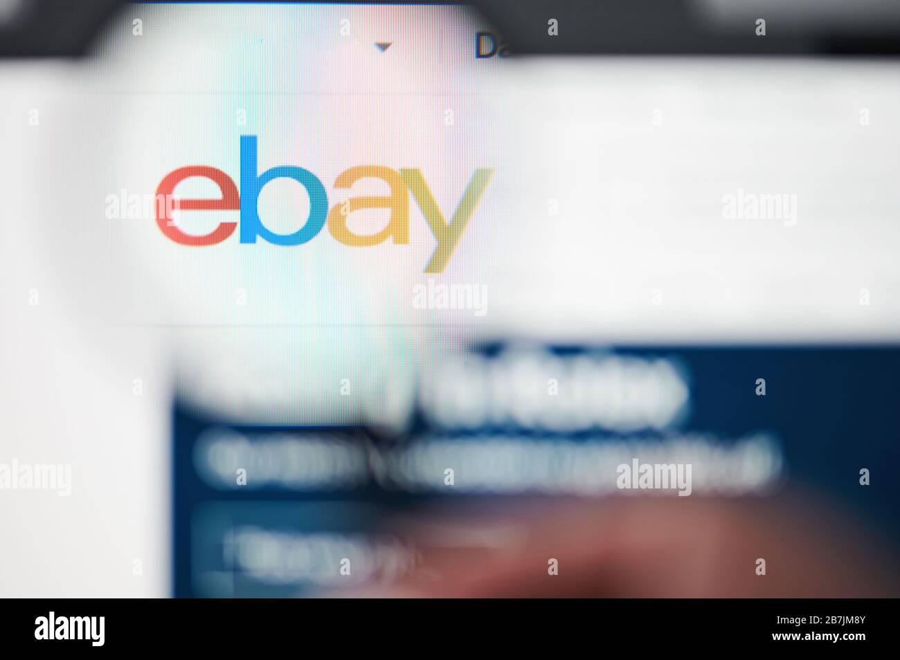 New-York , USA - March 13, 2020: Ebay online shopping web page on laptop screen close up view through magnifier Stock Photo