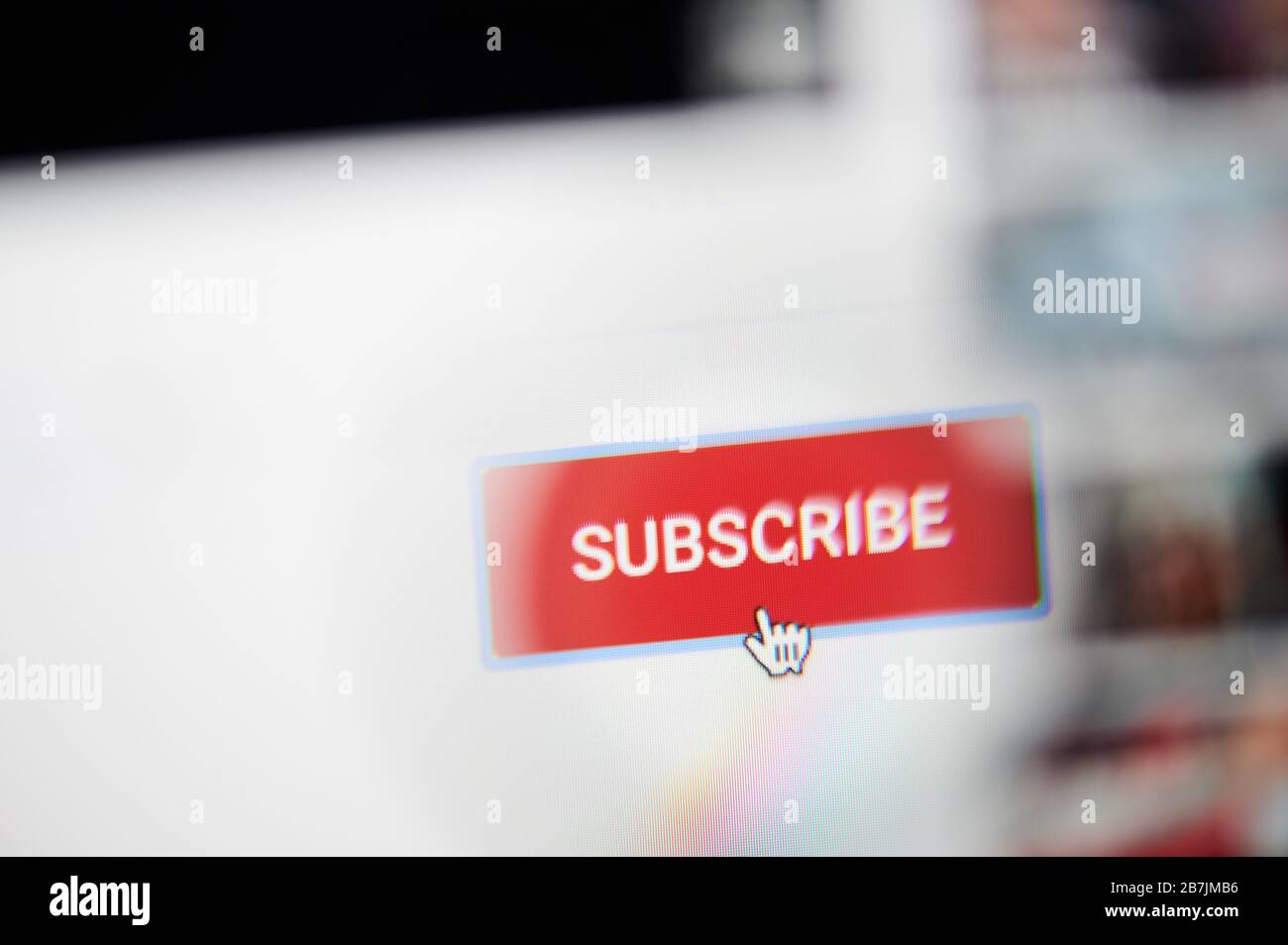 New-York , USA - March 13, 2020: Press subscribe button on youtube channel close up view through magnifier Stock Photo