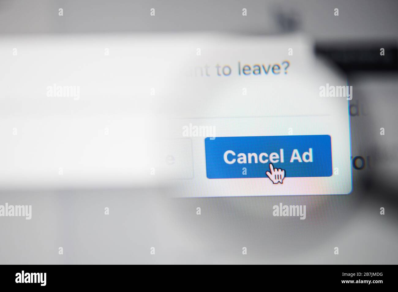 New-York , USA - March 13, 2020: Cancel ad in social media on laptop close up view throw magnifier Stock Photo