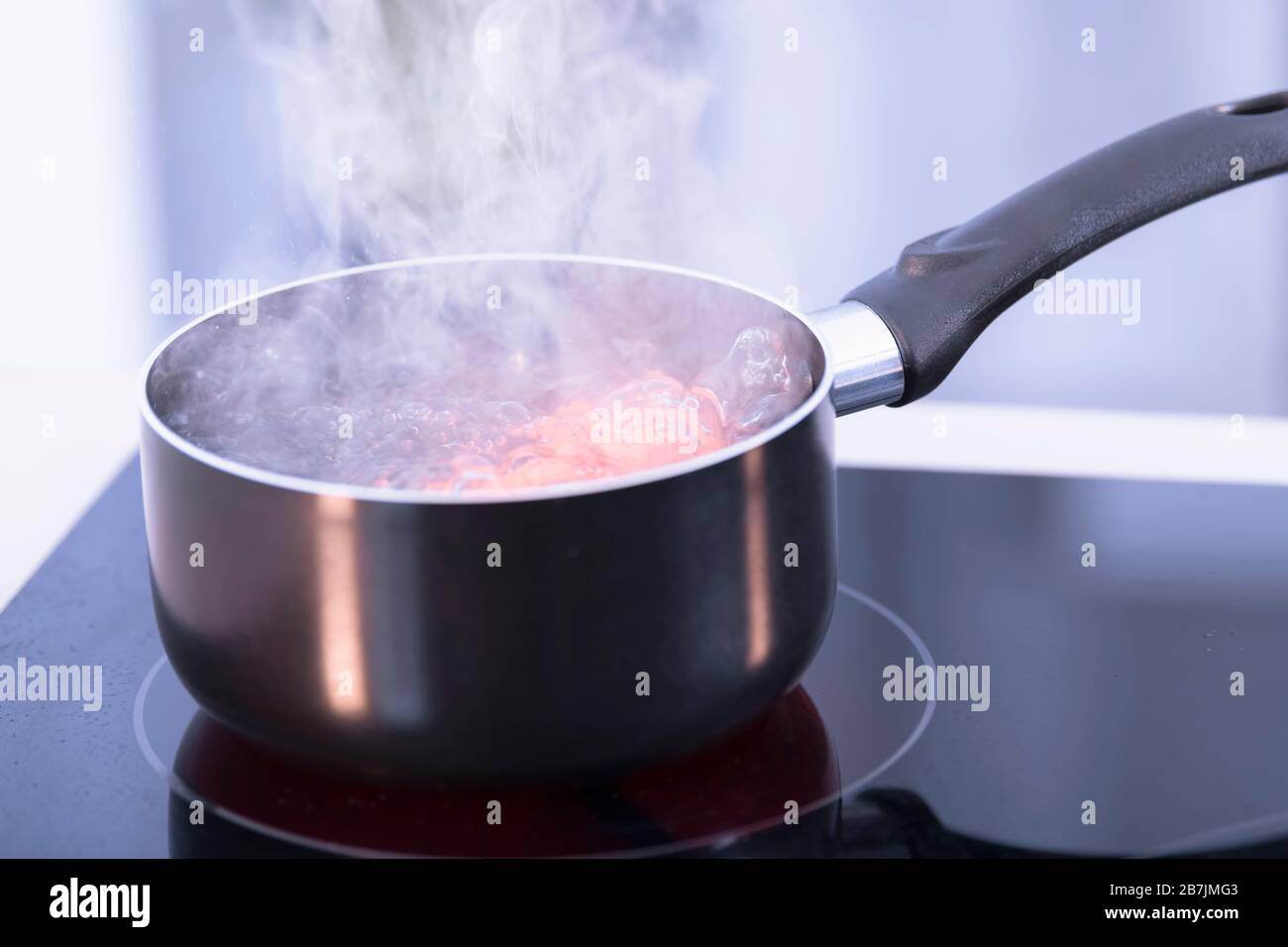 Saucepan with boiling water on a glass ceramic cooktop Stock Photo Alamy
