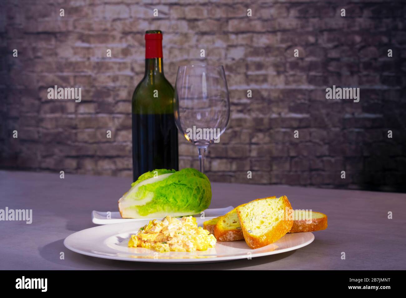 Scrambled eggs with bread and fresh lettuce Stock Photo