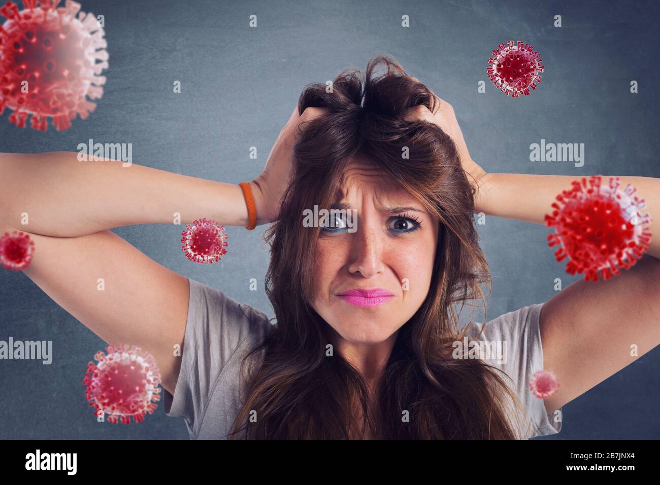 Feared girl attacked by viruses and bacteria. Concept of illness Stock Photo