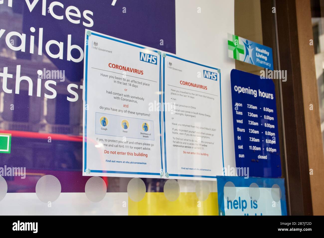 NHS Coronavirus public health information signs outside a Boots store in London Stock Photo