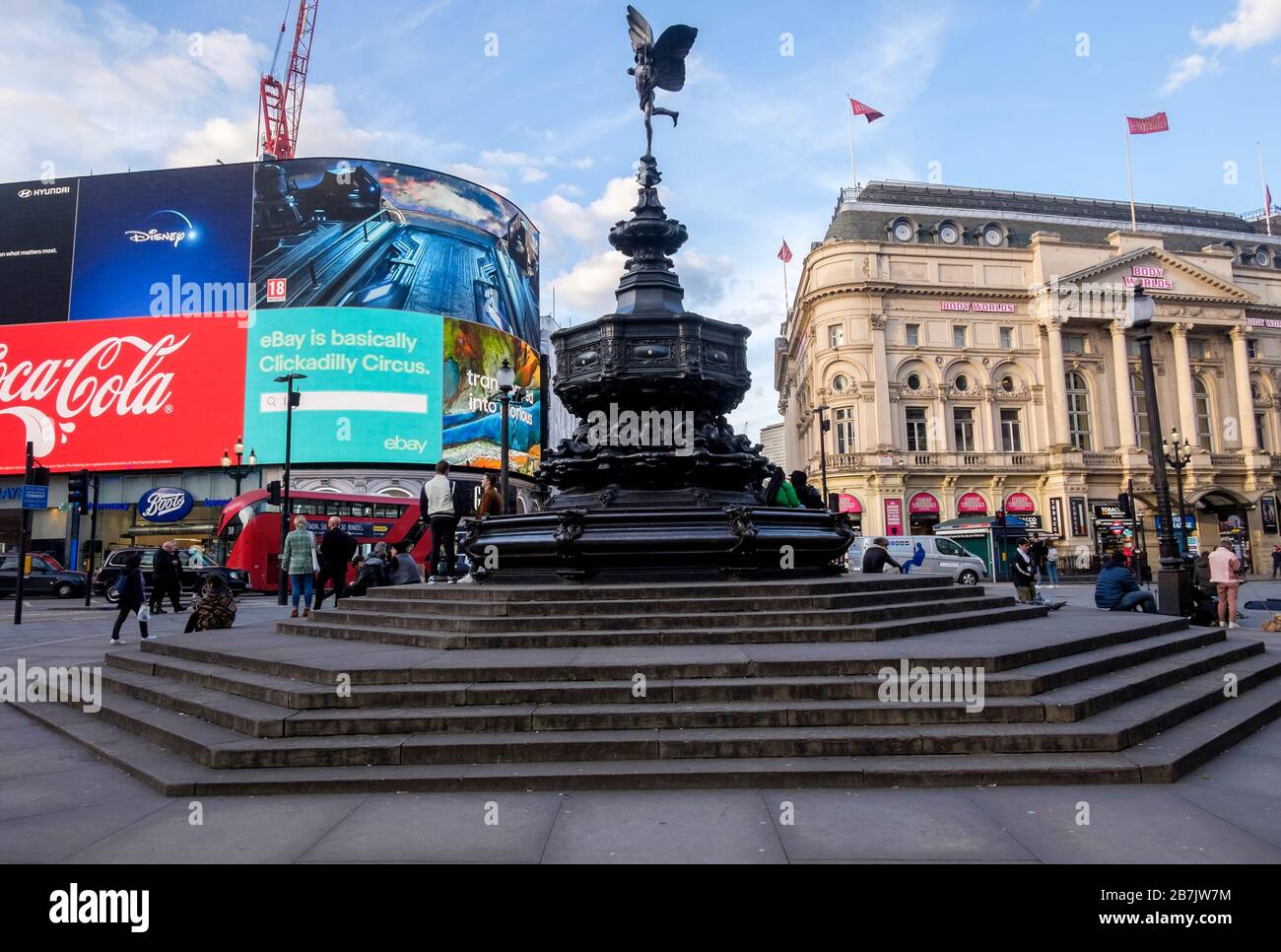 London, UK. 16th March 2020. Corona virus: The statue of Eros at Piccadilly Circus, normally a focal point for visitors to London is uncommonly quiet as people stay away from the city centre. Stock Photo