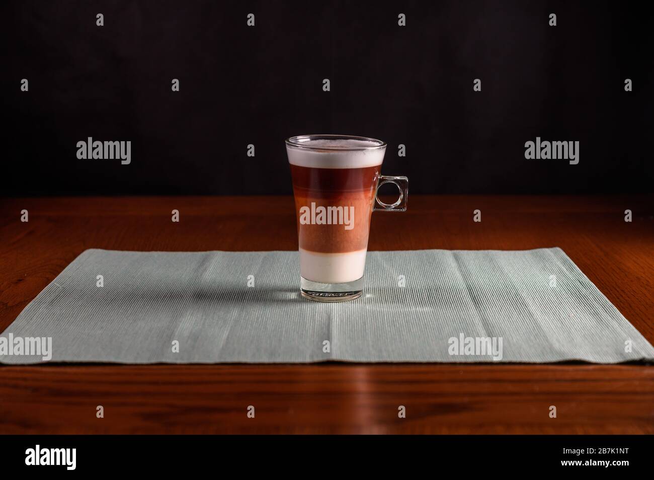 isolated cappuccino freshly brewed into a glass cup. wooden table, Stock Photo