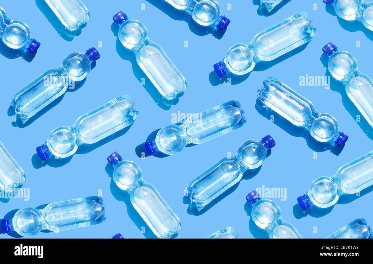 Mineral water bottles on blue background Stock Photo - Alamy