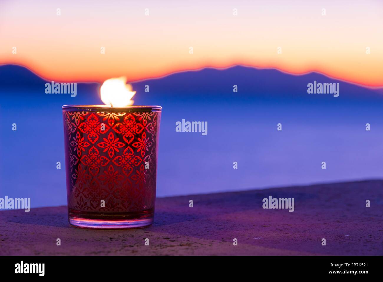 Beautiful candle glass at sunset in Italy with sea and Elba island in the background Stock Photo