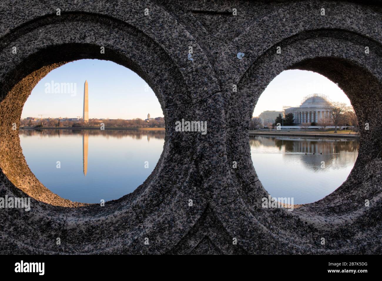 WASHINGTON, DC - The Washington Monument (left) and the Jefferson Memorial (right) framed through round portals on a small stone bridge over the Tidal Basin in Washington DC. Stock Photo